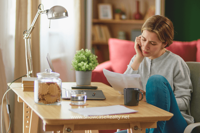 A woman reviews her bank statement as she plans to purchase a home among the Charlotte North Carolina Homes for Sale.