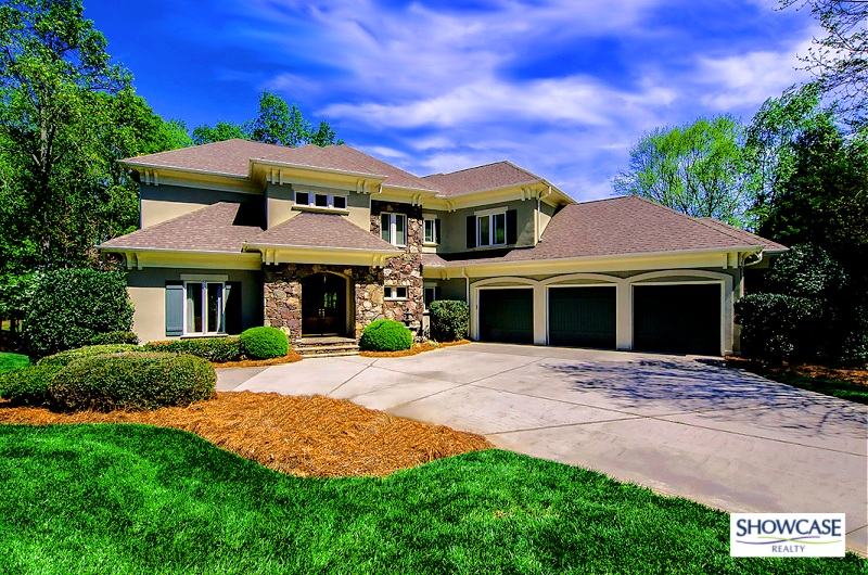 Ballantyne Charlotte NC Home For Sale Showcase Realty Beautiful two-story home with stone accents and a three-car garage in the Ballantyne Charlotte NC community, surrounded by lush greenery under a vibrant blue sky. Ideal for families seeking upscale living in Charlotte NC. Listed by Showcase Realty Ballantyne South Charlotte.