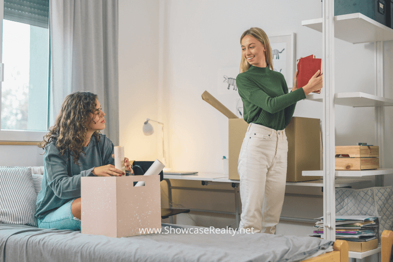 Two women organizing and staging a home, preparing it for sale, representing Showcase Realty’s home staging services to help maximize the value of Charlotte NC homes for sale and attract potential buyers in the competitive real estate market.
