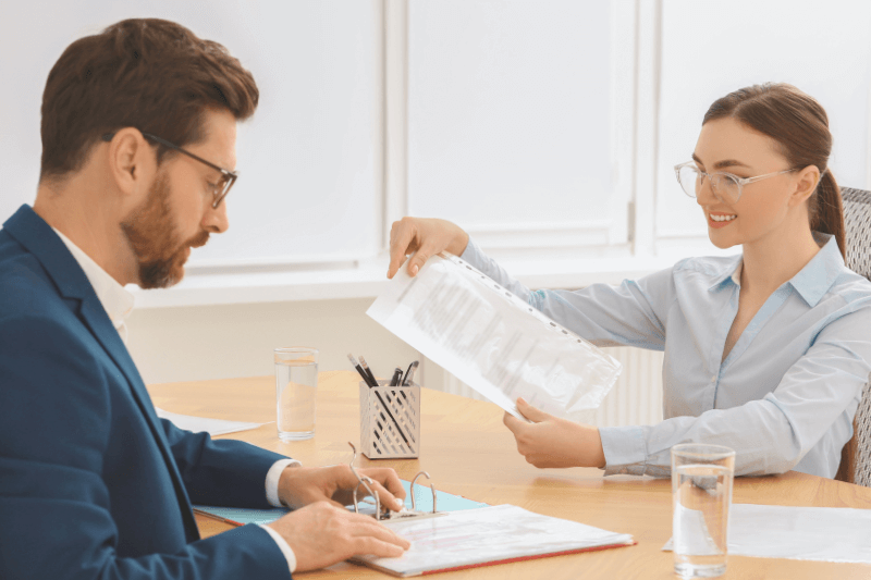 A professional real estate agent in Charlotte NC presenting property documents to a client during a consultation. The agent is explaining details about Charlotte North Carolina homes for sale, showcasing expertise and dedication to providing the best real estate services. The image reflects professionalism, trust, and commitment to helping clients make informed decisions.
