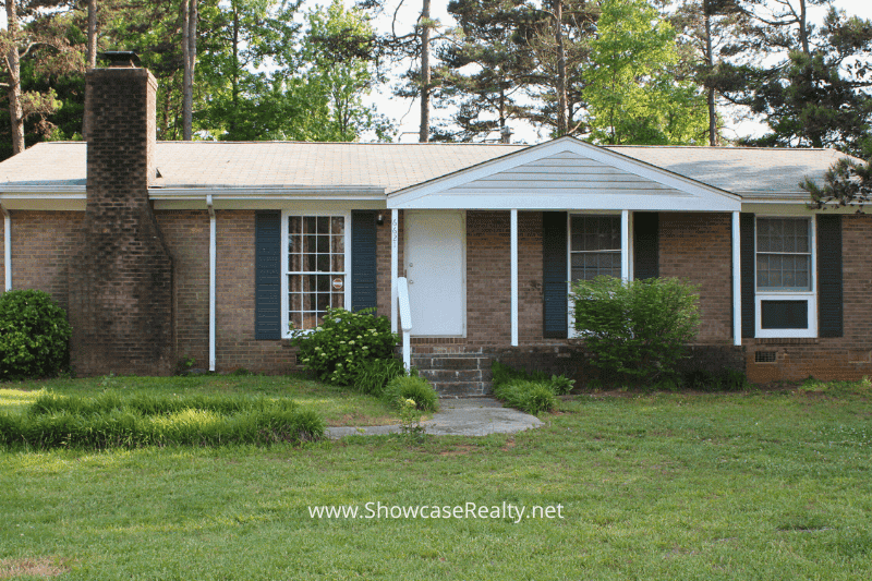 Single-story brick home in Little Rock Woods neighborhood — a classic Charlotte NC real estate listing offered by Showcase Realty, ideal for first-time home buyers or investors.
